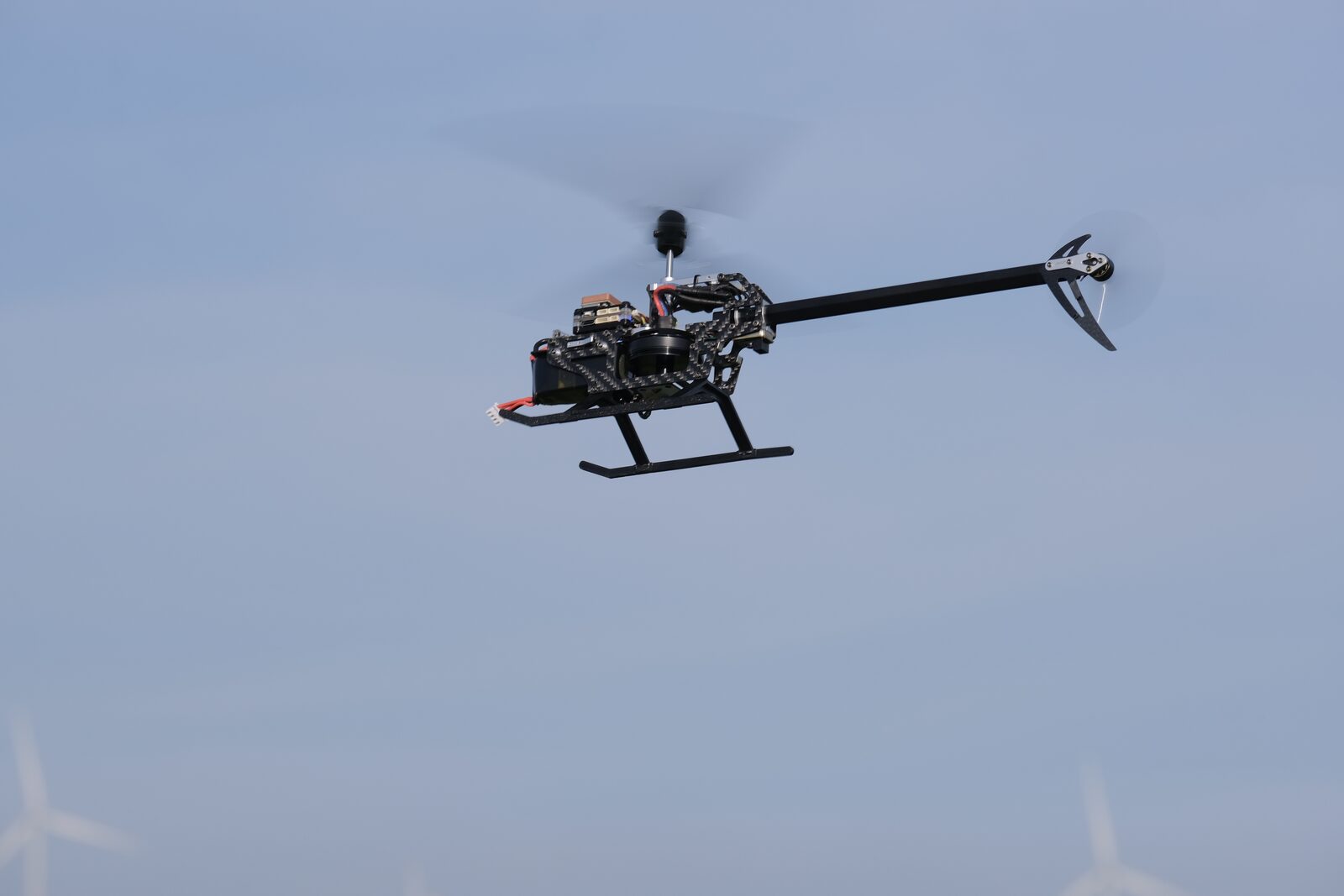 Swashplateless helicopter in flight, viewed against sky